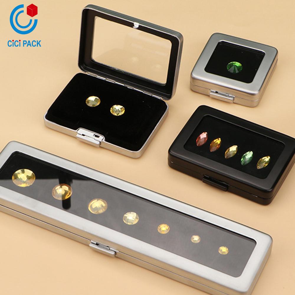 Press the metal square box with a glass surface A metal ring face showcases a loose diamond box